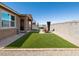 Beautiful backyard with artificial turf, a patio, firepit, and hot tub at 41800 W Sonoran Trl, Maricopa, AZ 85138