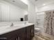 Bathroom features double sinks, a tub and shower combo, and a decorative shower curtain at 41800 W Sonoran Trl, Maricopa, AZ 85138