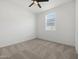 Neutral bedroom featuring a ceiling fan and a window with blinds for natural light at 41800 W Sonoran Trl, Maricopa, AZ 85138