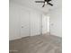 Clean, carpeted bedroom featuring a ceiling fan and doorways that provide convenient access at 41800 W Sonoran Trl, Maricopa, AZ 85138