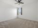 Bright bedroom featuring soft carpeting, a ceiling fan, and a window for natural light at 41800 W Sonoran Trl, Maricopa, AZ 85138