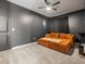Dark-walled bonus room features a unique daybed and a ceiling fan at 41800 W Sonoran Trl, Maricopa, AZ 85138