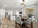 Inviting dining area open to the kitchen, featuring a modern light fixture and access to the patio at 41800 W Sonoran Trl, Maricopa, AZ 85138
