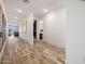 Bright hallway with hardwood floors, neutral walls, leading to the bedrooms and living areas at 41800 W Sonoran Trl, Maricopa, AZ 85138