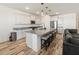 Open-concept kitchen with granite countertops, a large island with seating, and stainless steel appliances at 41800 W Sonoran Trl, Maricopa, AZ 85138