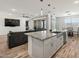 Bright, open-concept kitchen featuring a large island with granite countertops and pendant lighting at 41800 W Sonoran Trl, Maricopa, AZ 85138