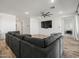 Spacious living room features wood-look flooring, recessed lights, and a comfortable sectional sofa at 41800 W Sonoran Trl, Maricopa, AZ 85138