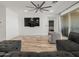 Bright living room featuring wood-look floors and a large sectional sofa, adjacent to the patio at 41800 W Sonoran Trl, Maricopa, AZ 85138