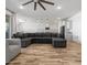 Spacious living room featuring an open-concept design with a large sectional and modern finishes at 41800 W Sonoran Trl, Maricopa, AZ 85138