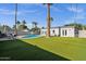 A lovely backyard featuring a sparkling pool, lush artificial grass, and a private outdoor living space perfect for entertaining at 4216 N 20Th St, Phoenix, AZ 85016