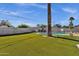 A private backyard features a beautiful lawn, a sparkling pool, lounge area, and hot tub for ultimate relaxation and enjoyment at 4216 N 20Th St, Phoenix, AZ 85016