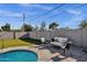 A backyard featuring an in-ground pool, an outdoor patio, and an expansive lawn at 4216 N 20Th St, Phoenix, AZ 85016