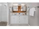 This updated bathroom features a spacious double vanity, modern mirrors, and sleek lighting for an elegant touch at 4216 N 20Th St, Phoenix, AZ 85016