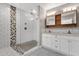 Bright bathroom featuring a walk-in shower, double sink vanity, and modern fixtures at 4216 N 20Th St, Phoenix, AZ 85016