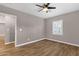This bedroom features wood-look floors, a ceiling fan, and a window with shutters at 4216 N 20Th St, Phoenix, AZ 85016