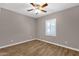 Cozy bedroom featuring wood floors, a ceiling fan, and plantation shutters at 4216 N 20Th St, Phoenix, AZ 85016
