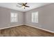 Bedroom featuring wood floors, ceiling fan, and plantation shutters at 4216 N 20Th St, Phoenix, AZ 85016