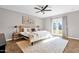 Well-lit bedroom features a ceiling fan, hardwood floors, and a cozy rug, blending style with functionality at 4216 N 20Th St, Phoenix, AZ 85016