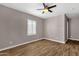 This bedroom features wood-look floors, a ceiling fan, and a window with shutters at 4216 N 20Th St, Phoenix, AZ 85016