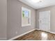 A simple bedroom with light hardwood floors and a modern door and window at 4216 N 20Th St, Phoenix, AZ 85016