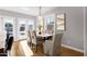 This dining room features a stylish light fixture, wood table, and large windows for natural light at 4216 N 20Th St, Phoenix, AZ 85016