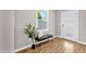Bright entryway features wood floors, a bench, a decorative tree and a door with glass panes at 4216 N 20Th St, Phoenix, AZ 85016