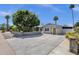 Charming home exterior with lush green trees, side yard, and large driveway at 4216 N 20Th St, Phoenix, AZ 85016