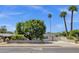 Charming home exterior with lush green trees, side yard, and large driveway at 4216 N 20Th St, Phoenix, AZ 85016