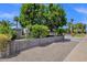 Charming home exterior with lush green trees, side yard, and large driveway at 4216 N 20Th St, Phoenix, AZ 85016