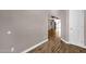 Hallway featuring modern hardwood floors and neutral walls, leading into an open-concept living area at 4216 N 20Th St, Phoenix, AZ 85016