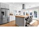 Open kitchen with stainless appliances, island with breakfast bar, and view of the backyard pool at 4216 N 20Th St, Phoenix, AZ 85016