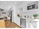 Bright kitchen features white cabinetry, stainless steel appliances, subway tile backsplash and hardwood flooring at 4216 N 20Th St, Phoenix, AZ 85016