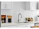 Modern white kitchen with subway tile backsplash, stainless steel faucet and stainless steel appliances at 4216 N 20Th St, Phoenix, AZ 85016