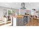 View of the kitchen island with stainless vent hood and a dining area, all illuminated by natural light at 4216 N 20Th St, Phoenix, AZ 85016