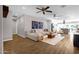 Open concept living room boasts wood floors, ceiling fans, a large sofa and a modern aesthetic at 4216 N 20Th St, Phoenix, AZ 85016