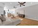 Spacious living room with wood floors, ceiling fans, comfortable seating and a modern entertainment center at 4216 N 20Th St, Phoenix, AZ 85016