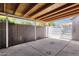 Covered patio with concrete floor, block wall, white metal gate, and exposed wood rafters at 4216 N 20Th St, Phoenix, AZ 85016