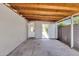 Covered patio with concrete floor, block wall, white trim, and a white exterior door open to green space at 4216 N 20Th St, Phoenix, AZ 85016