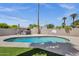 Backyard features a sparkling pool, hot tub, and basketball hoop, surrounded by lush green landscaping and a privacy wall at 4216 N 20Th St, Phoenix, AZ 85016