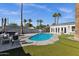 A stunning backyard with a gorgeous pool, palm trees, lounge chairs, and a relaxing spa provides an oasis for outdoor enjoyment at 4216 N 20Th St, Phoenix, AZ 85016