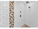 This modern walk-in shower offers a sleek design with contemporary tiles and a dual shower head for a luxurious feel at 4216 N 20Th St, Phoenix, AZ 85016