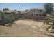 View of backyards featuring block wall fences and palm trees at 42435 W Desert Fairways Dr, Maricopa, AZ 85138