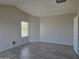 Bedroom with vaulted ceiling, light floors, and bright windows at 42435 W Desert Fairways Dr, Maricopa, AZ 85138