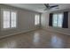 Bedroom featuring tile flooring, ceiling fan, and natural light at 42435 W Desert Fairways Dr, Maricopa, AZ 85138