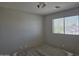 Bedroom featuring a bed frame without a headboard and a window with blinds, set against neutral-colored walls at 42435 W Desert Fairways Dr, Maricopa, AZ 85138