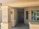 Inviting entryway with neutral tones, decorative pillars, and a secure front door at 42435 W Desert Fairways Dr, Maricopa, AZ 85138