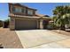 Two-story home featuring a tile roof, attached two car garage and desert landscaping at 42435 W Desert Fairways Dr, Maricopa, AZ 85138