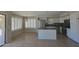 Open kitchen and dining area with white cabinets and lots of light at 42435 W Desert Fairways Dr, Maricopa, AZ 85138