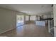 Open floor plan with large windows and sliding glass doors leading to the patio at 42435 W Desert Fairways Dr, Maricopa, AZ 85138