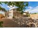 A spacious backyard with an extended covered patio and tranquil water feature at 4387 E Hartford Ave, Phoenix, AZ 85032